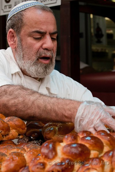 20100409_150653 D300.jpg - Vendor tenderly places his Challahs on display. Ben Yehuda Market, Jerusalem